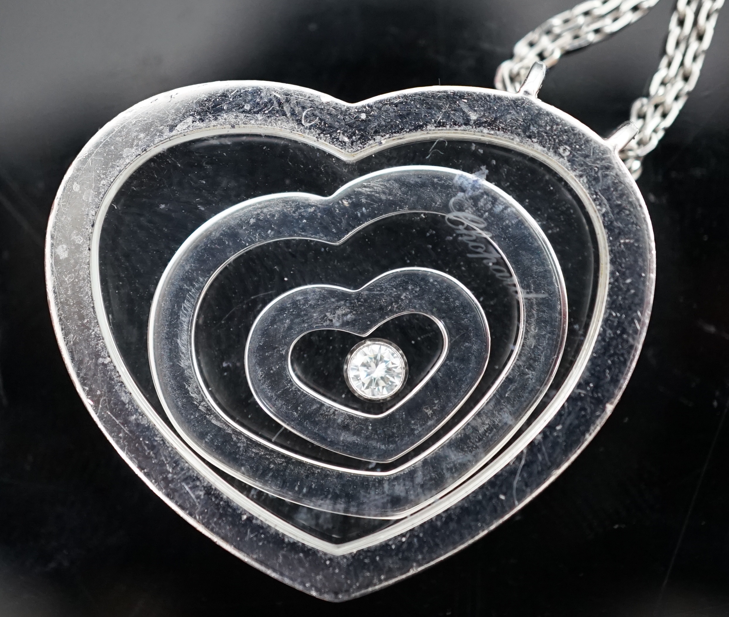 A modern Chopard 18ct white gold and diamond set 'Happy Spirit' heart shape pendant, on a Chopard 18ct white gold double strand fine link chain